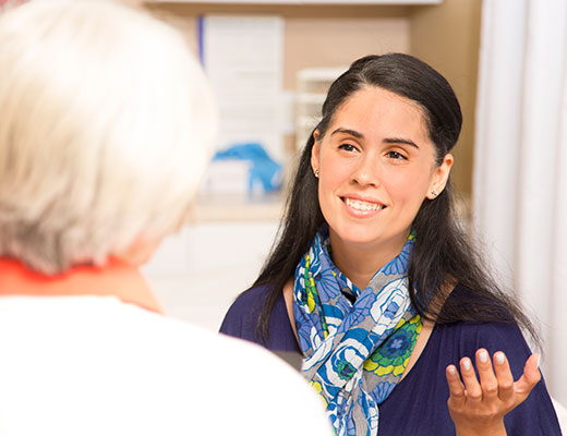 Student in the Columbia Online MSSW Advanced Standing program listening to a patient