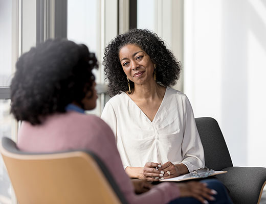 Student in the Columbia Online MSSW One-Year Residency for Working Professionals (Reduced Residency) listening to a patient