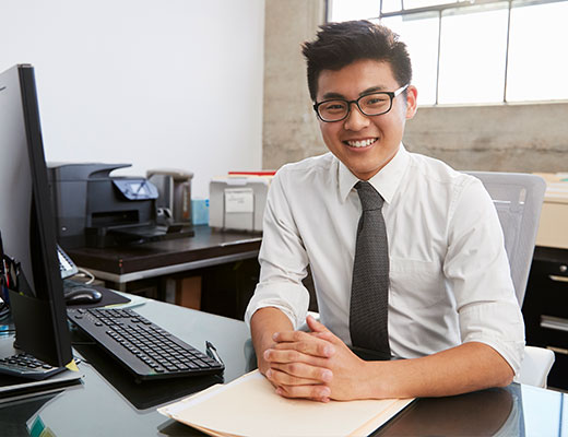 Student in the Columbia Online MSSW Transfer program sitting at a computer desk