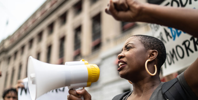 A woman talking through a megaphone
