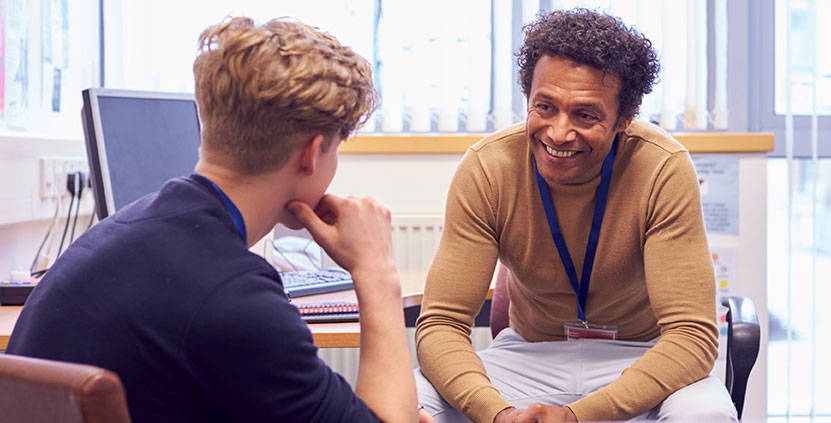 Two men talking at a meeting table